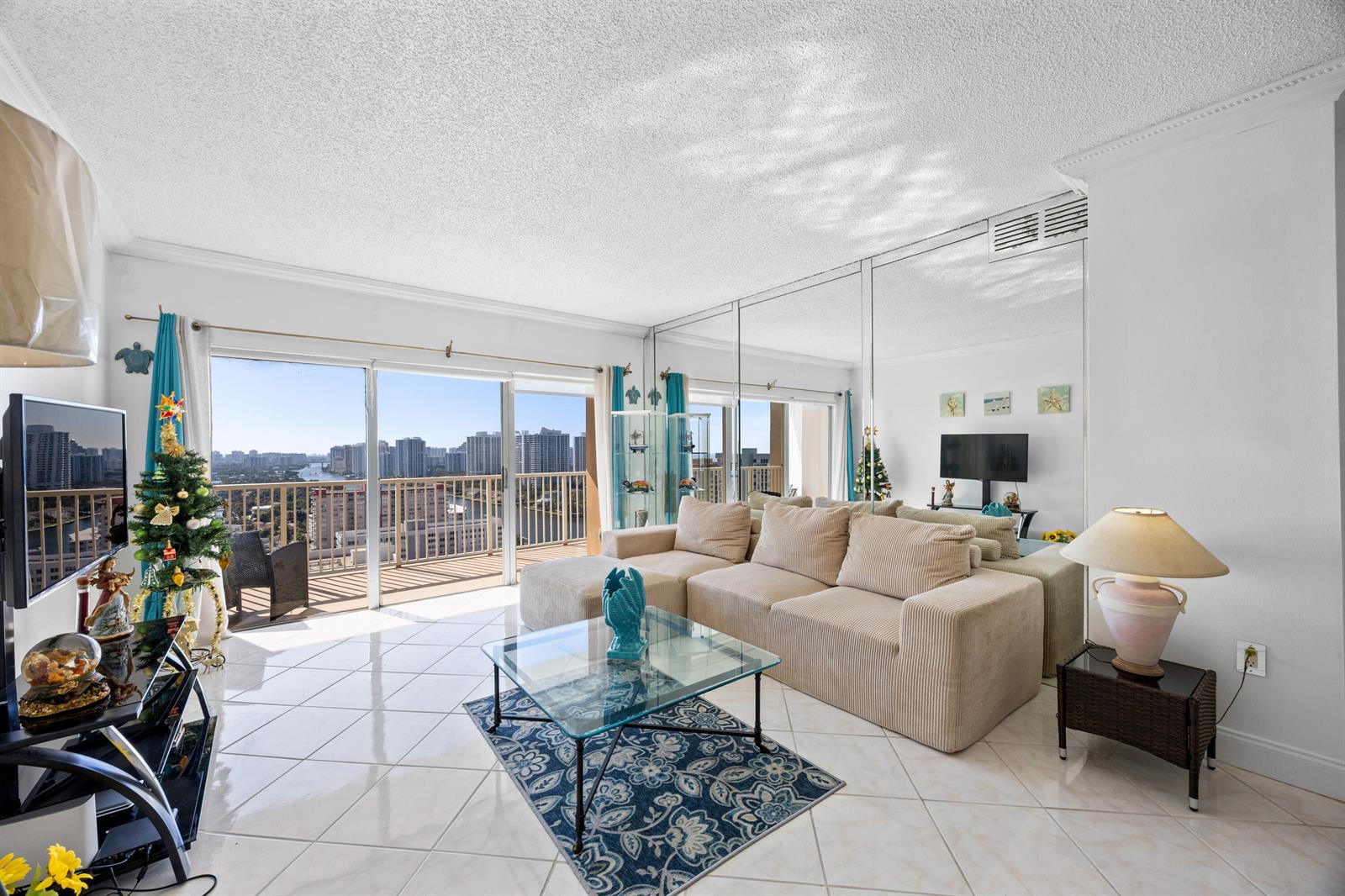 A balcony with two wicker chairs overlooks a city street and high-rise buildings — 1985 S Ocean Drive, Hallandale Beach FL 33009, HALLANDALE BEACH, FL