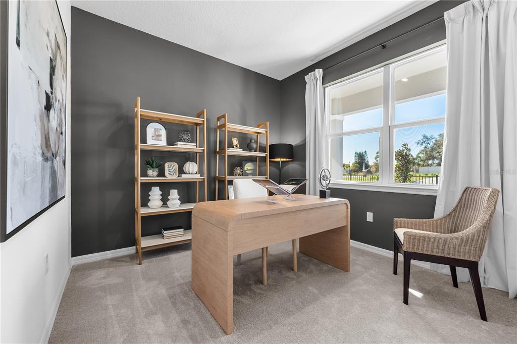 A home office features a wooden desk, two open shelves, and a window with curtains — 1813 SHADOW BOX BEND, ST CLOUD, FL