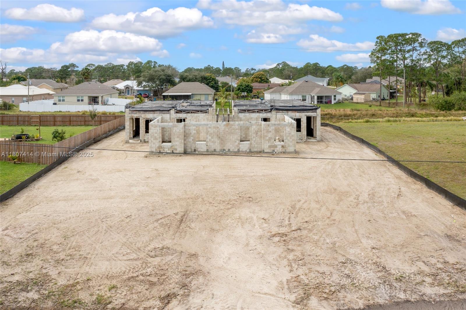 An aerial view shows a residential construction site with concrete block walls for a duplex — 2826 2830 HESTER AVE, Palm Bay FL 32909, PALM BAY, FL