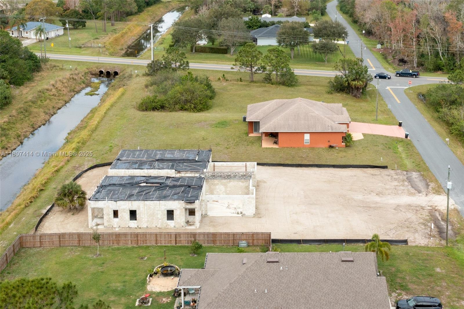 An aerial view shows a house under construction next to a finished orange home — 2826 2830 HESTER AVE, Palm Bay FL 32909, PALM BAY, FL