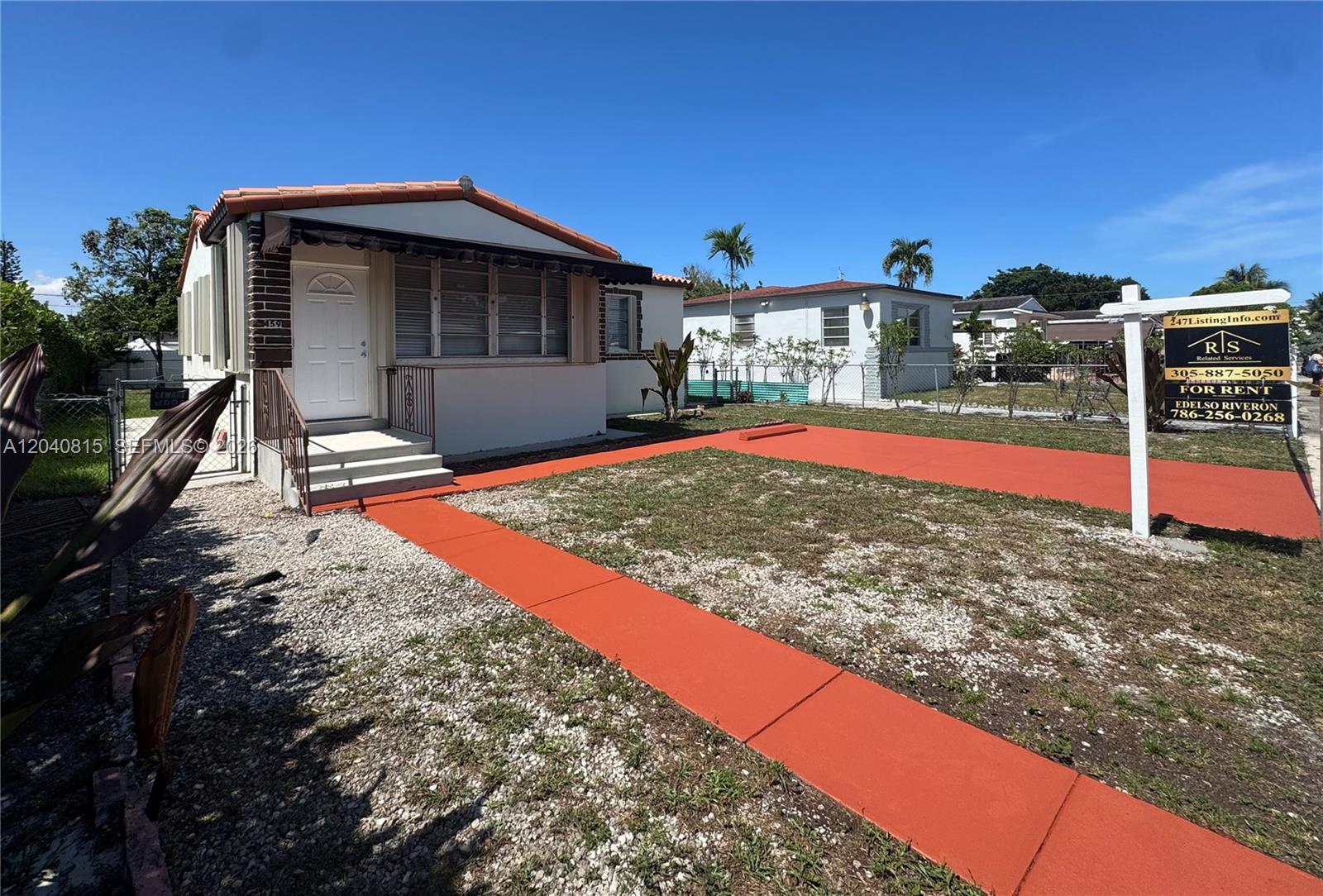 A small, single-story house features a red-painted driveway and walkway with a rental sign — 459 SE 3rd St, Hialeah FL 33010, HIALEAH, FL