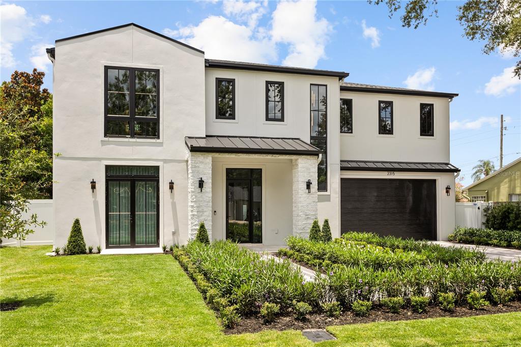 A modern two-story house with white stucco walls, black window frames, and a stone entryway — 2315 WEBER STREET, ORLANDO, FL