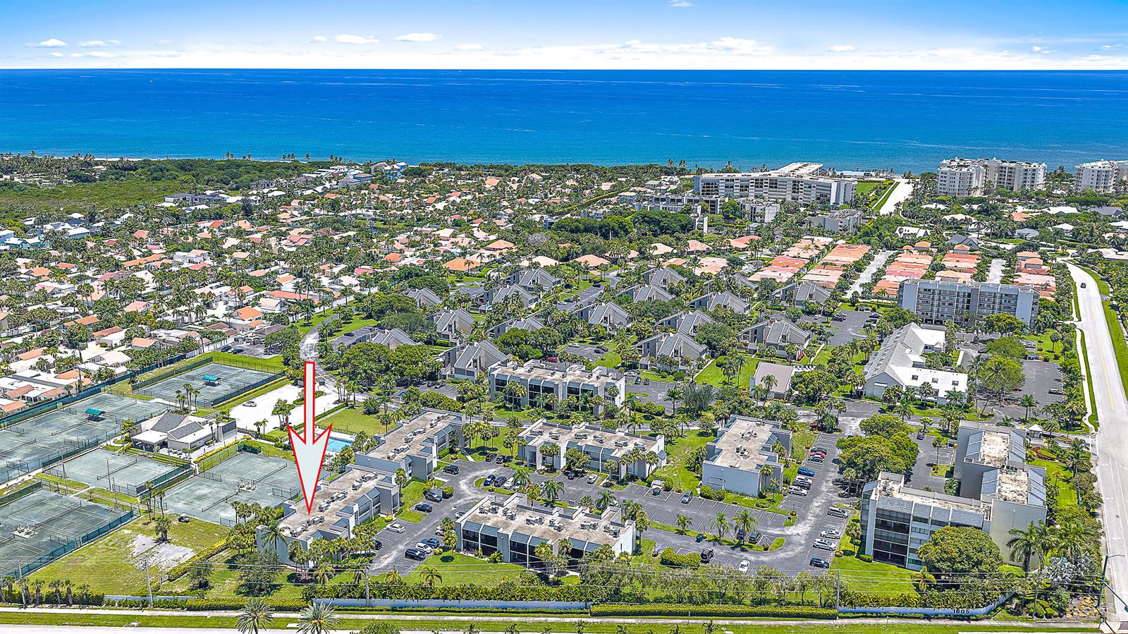 An aerial view shows a multi-story residential complex with tennis courts and surrounding tropical landscaping — 1605 S Us Highway 1, Jupiter FL 33477, JUPITER, FL