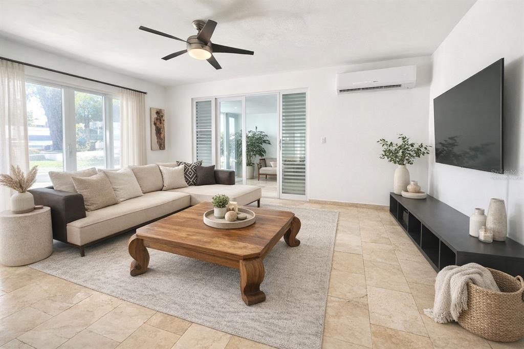 A bright living room features a sectional sofa, wooden coffee table, and tile flooring — 17 GUERRERO NOBLE, SAN JUAN, PR