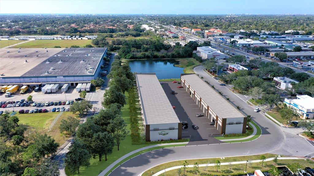 This is an aerial rendering of two commercial warehouse buildings situated next to a pond — 5864 DEREK AVENUE UNIT 1-2, SARASOTA, FL