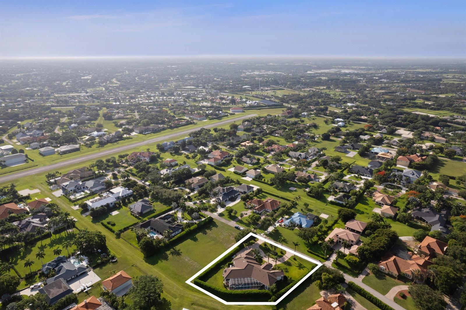 An aerial view shows a residential property with a pool enclosed by a white outline — 15885 Boeing Court, Wellington FL 33414, WELLINGTON, FL