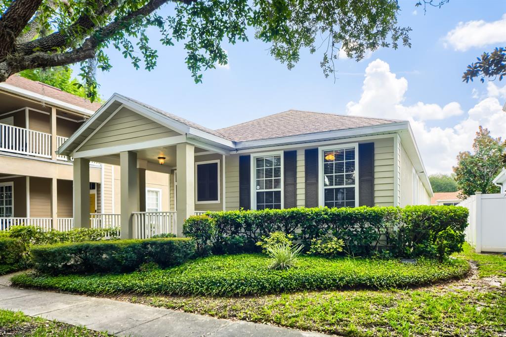 A single-story house with light siding, dark shutters, and a covered front porch — 3305 BRACKEN FERN DRIVE, HARMONY, FL