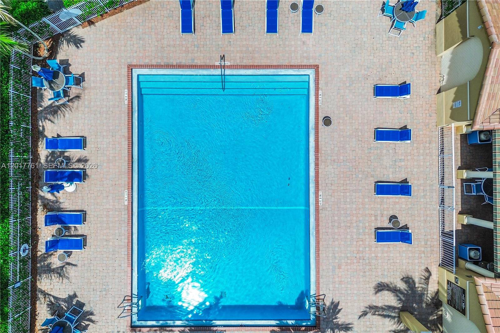 An aerial view shows a rectangular swimming pool surrounded by a brick patio and lounge chairs — 12172 SW 124th Path, Miami FL 33186, MIAMI, FL