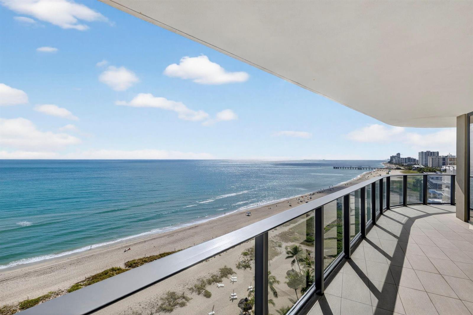 A high-rise balcony overlooks a sandy beach and the ocean under a blue sky — 730 N Ocean Boulevard # 1204, Pompano Beach FL 33062, POMPANO BEACH, FL