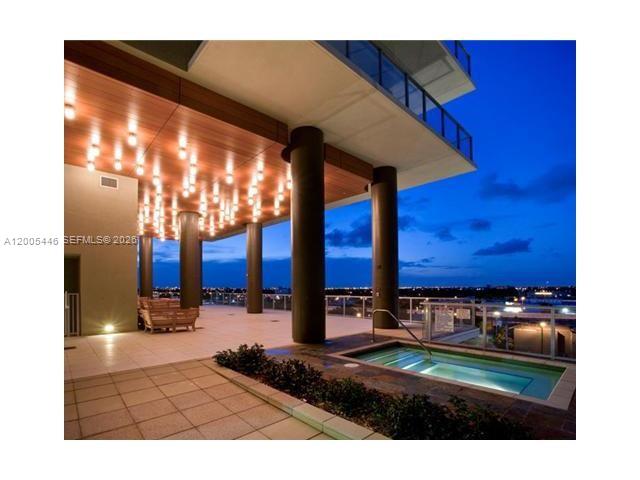 An outdoor terrace features a small pool, dark pillars, and a ceiling with many lights — 3470 E Coast Ave # H1503, Miami FL 33137, MIAMI, FL