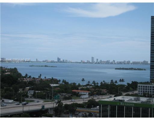 An elevated view of a bay with a distant city skyline and a highway below — 3470 E Coast Ave # H1503, Miami FL 33137, MIAMI, FL