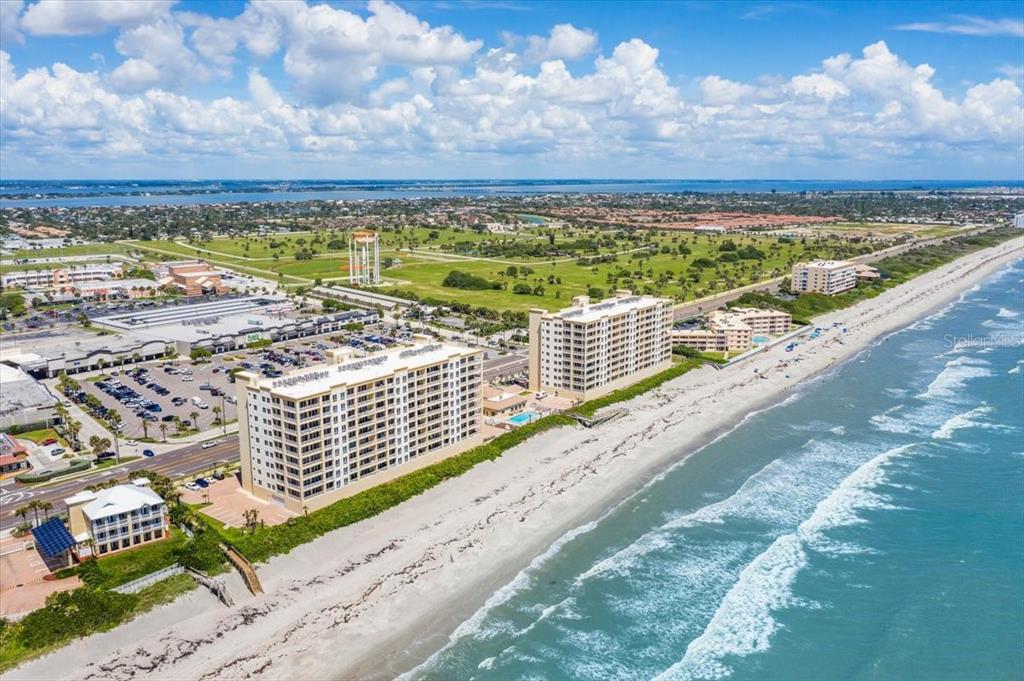 An aerial view of two large beachfront condominium buildings next to a sandy beach — 1025 HIGHWAY A1A UNIT 406, SATELLITE BEACH, FL