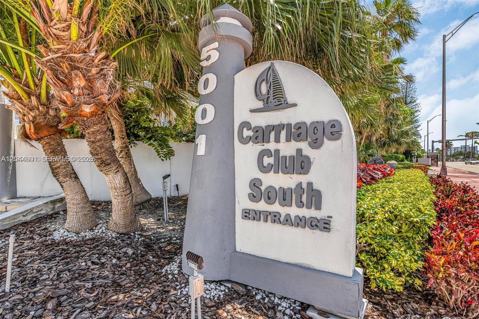 A gray monument sign for Carriage Club South stands near palm trees and landscaping — 5001 Collins Ave # 9H, Miami Beach FL 33140, MIAMI BEACH, FL