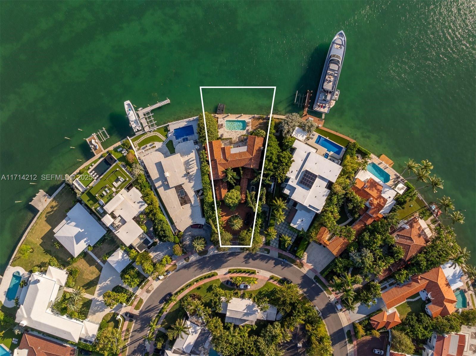 An aerial view shows a waterfront residential property with a pool and private dock — 11 E Rivo Alto Dr, Miami Beach FL 33139, MIAMI BEACH, FL