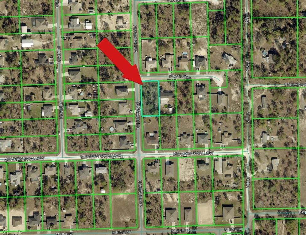 This is an aerial map showing a vacant residential lot highlighted in a suburban neighborhood — 10480 FLYCATCHER ROAD, BROOKSVILLE, FL