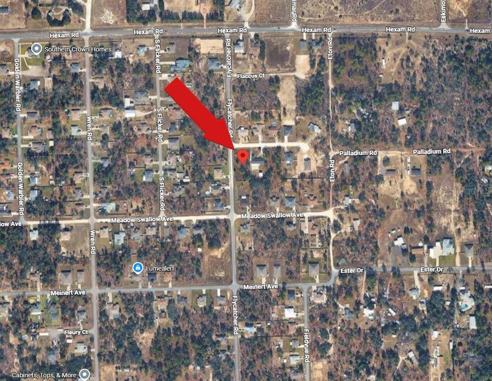 This is an aerial map view of a residential neighborhood with a red location pin — 10480 FLYCATCHER ROAD, BROOKSVILLE, FL