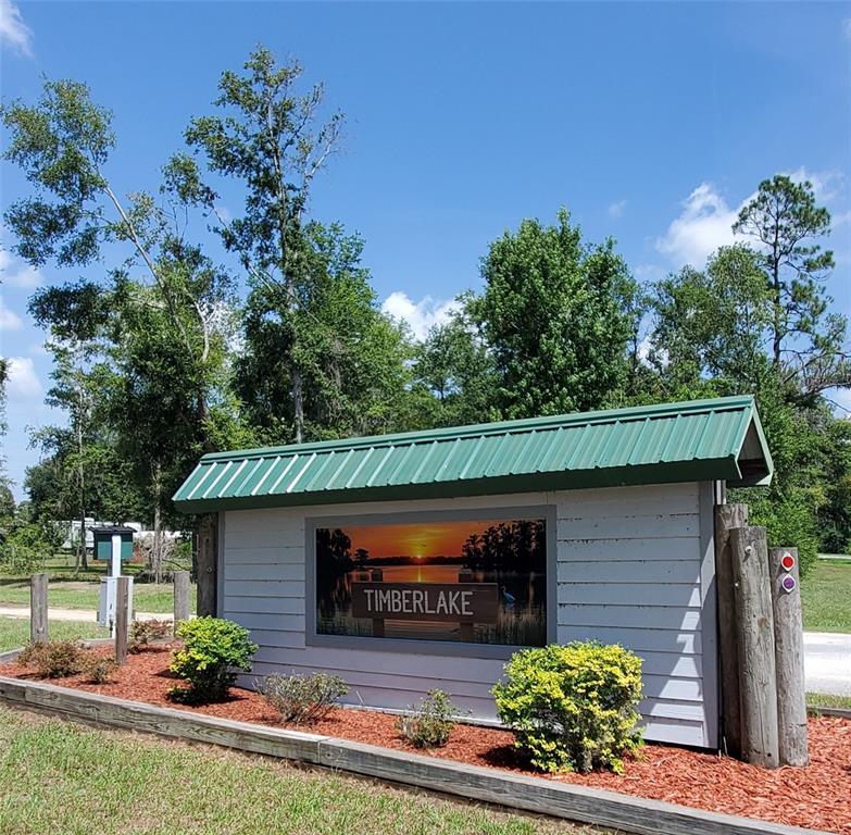 A white sign with a green metal roof displays the name Timberlake near trees — LOT11 NW 63RD BLVD, JENNINGS, FL