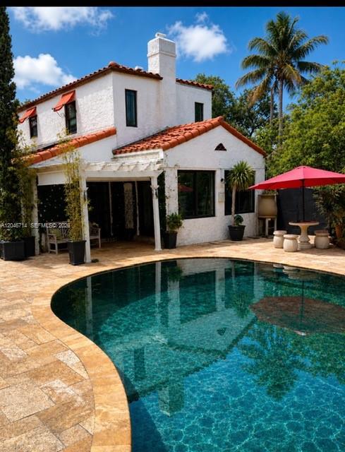 A lush backyard features a green artificial turf lawn, tropical plants, and a stone walkway — 8276 E Dixie Hwy, Miami FL 33138, MIAMI, FL