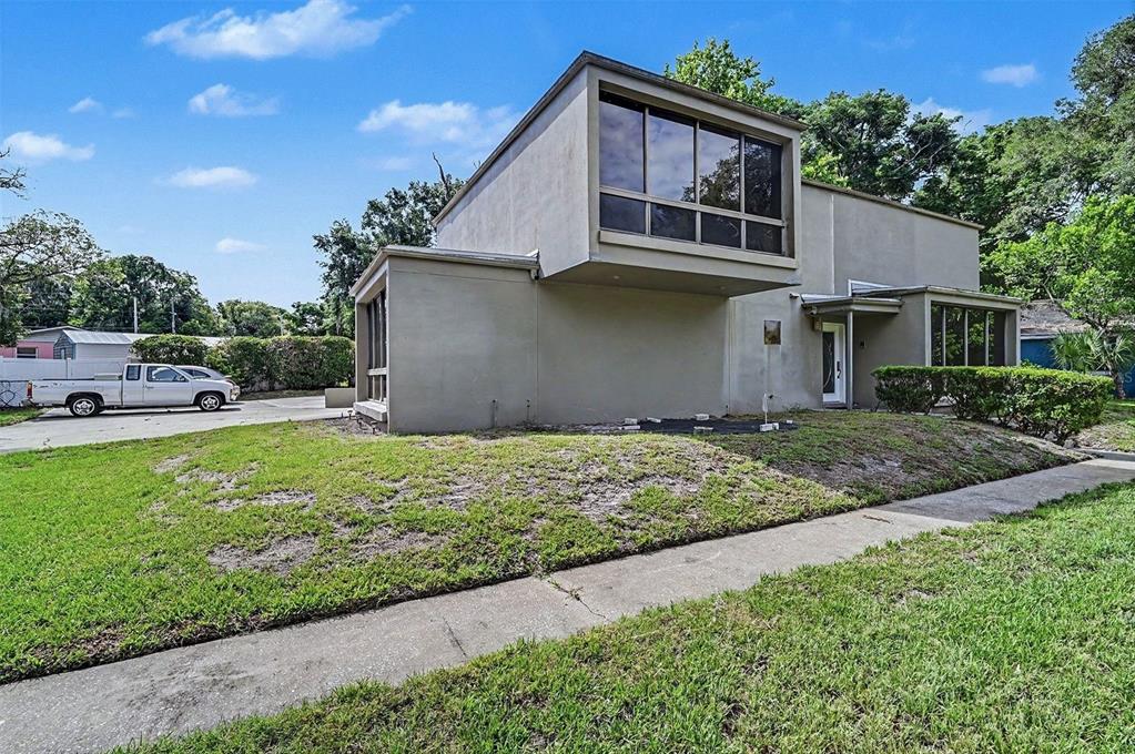 A two-story house with a cantilevered upper level and a flat roof exterior — 633 S DELAWARE AVENUE, DELAND, FL