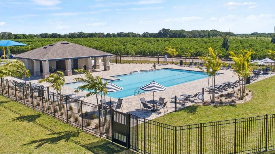 An outdoor swimming pool area features a covered pavilion, lounge chairs, and umbrellas — 3076 CAPTAIN JAX WAY, WINTER HAVEN, FL