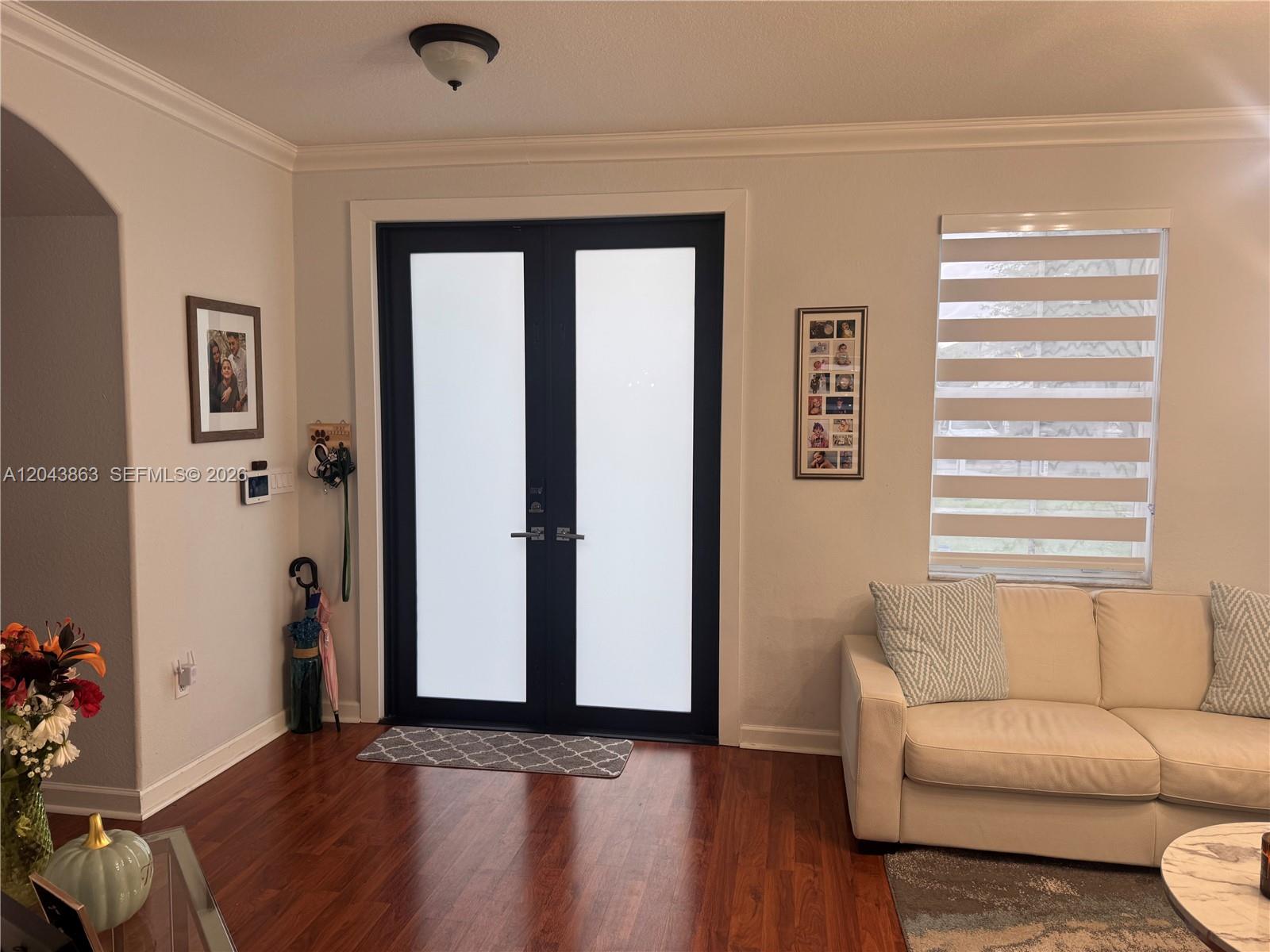 A living room features a double front door with frosted glass and hardwood flooring — 15376 SW 13th Ter, Miami FL 33194, MIAMI, FL