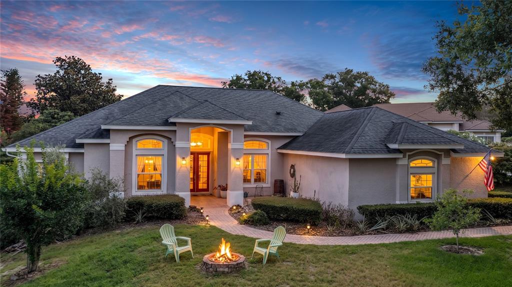 A single-story house with a fire pit and two chairs in the front yard — 9113 IVEY HILL COURT, ORLANDO, FL