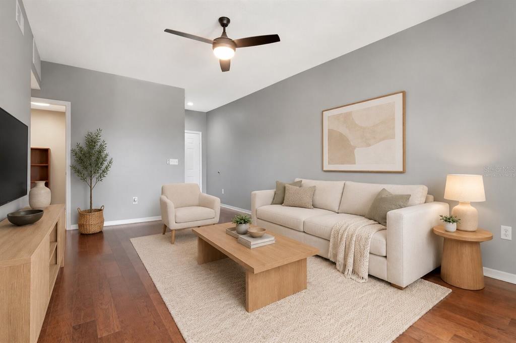 A living room features a beige sofa, a wooden coffee table, and hardwood flooring — 2010 E PALM AVENUE UNIT 15310, TAMPA, FL