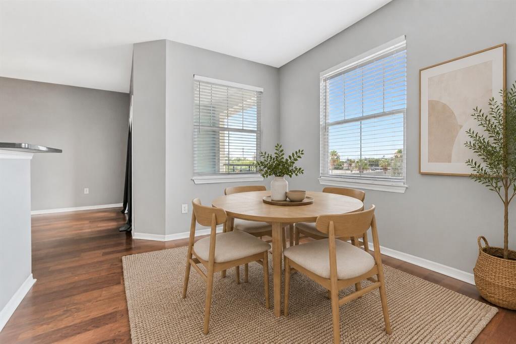 A balcony features two wicker chairs, a small round table, and a view of sunset — 2010 E PALM AVENUE UNIT 15310, TAMPA, FL