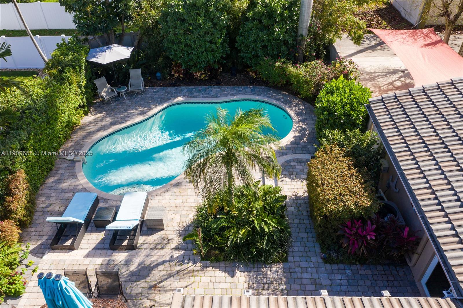 An aerial view shows a backyard with a swimming pool, patio, and lush landscaping — 418 SE 3rd Ter # 0, Dania Beach FL 33004, DANIA BEACH, FL
