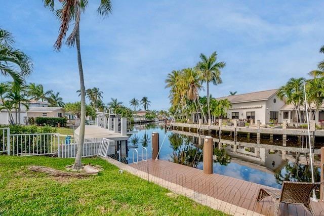 A wooden dock extends into a canal lined with palm trees and waterfront houses — 1131 SE 5th Avenue, Pompano Beach FL 33060, POMPANO BEACH, FL