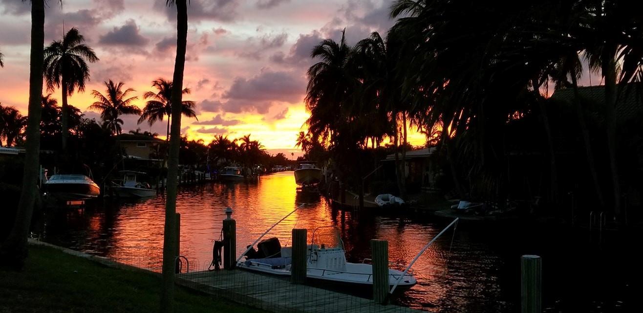 A sunset view over a canal with docked boats and silhouetted palm trees — 1131 SE 5th Avenue, Pompano Beach FL 33060, POMPANO BEACH, FL