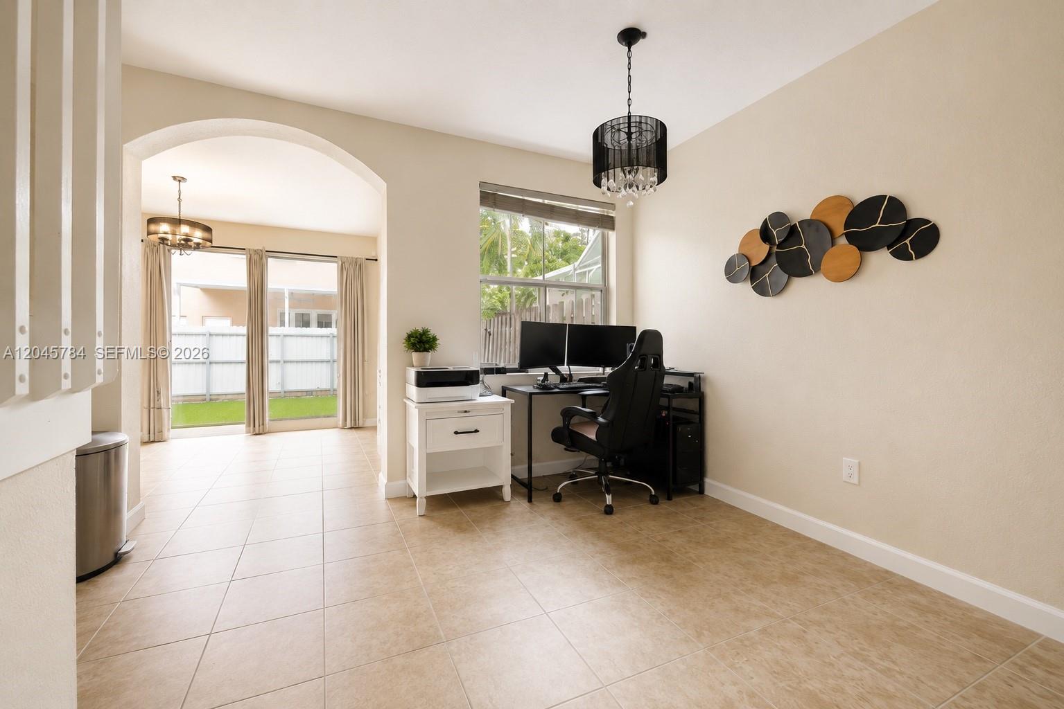 A home office features a desk, dual monitors, a chandelier, and tile flooring — 3512 SW 171st Ave, Miramar FL 33027, MIRAMAR, FL