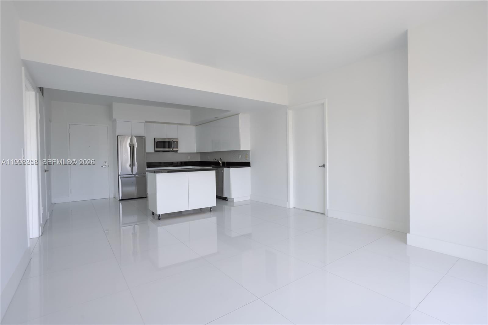 A modern kitchen with white cabinets, stainless steel appliances, and a portable island — 92 SW 3rd St # 3512, Miami FL 33130, MIAMI, FL