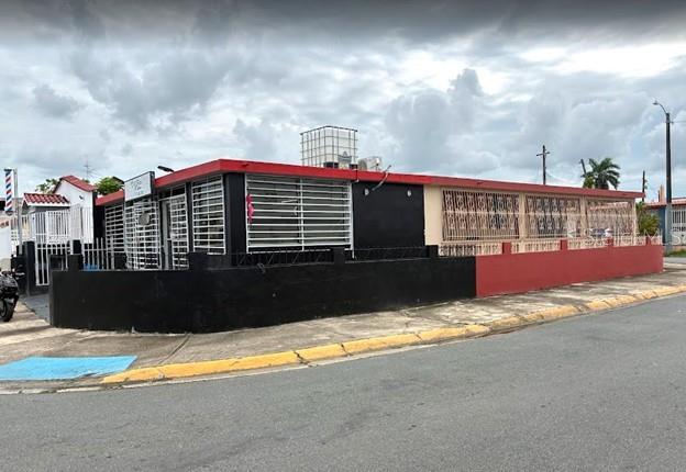 A single-story commercial building with black and red exterior walls and security bars — 11 LAS VEGAS DEVELOPMENT UNIT N-1, CATANO, PR