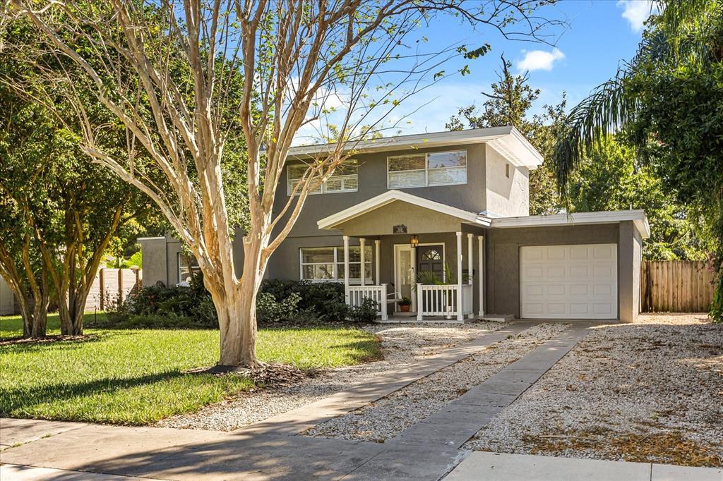 A two-story gray house with a front porch, garage, and a gravel driveway — 2418 EUSTON ROAD, WINTER PARK, FL