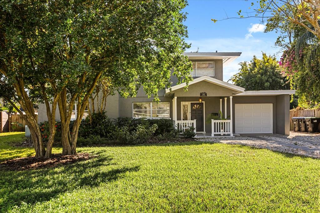 A two-story house with a gray exterior, a front porch, and a single-car garage — 2418 EUSTON ROAD, WINTER PARK, FL