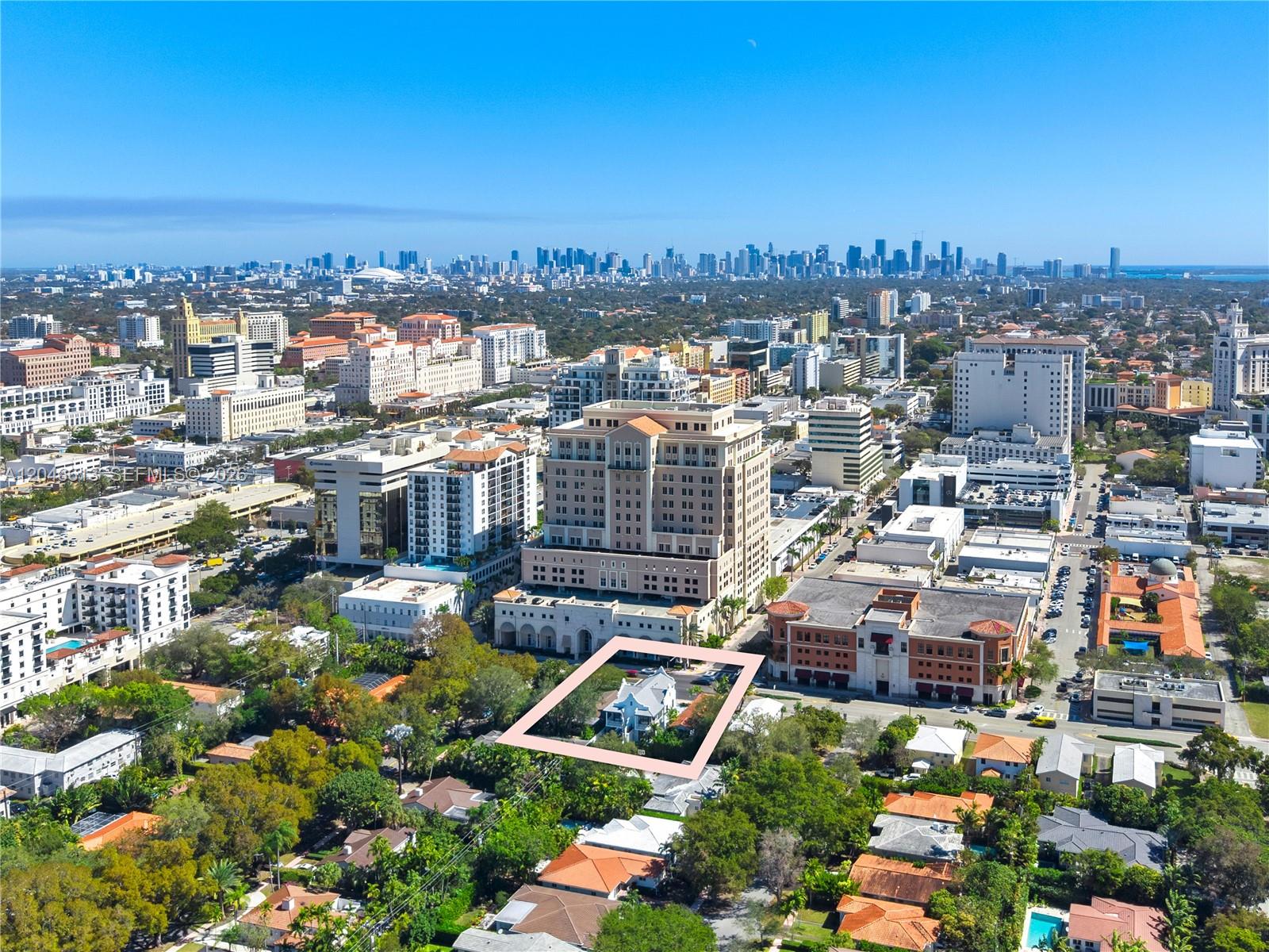An aerial view shows a single-family home highlighted within a pink border in a city — 2710 S Le Jeune Rd, Coral Gables FL 33134, CORAL GABLES, FL