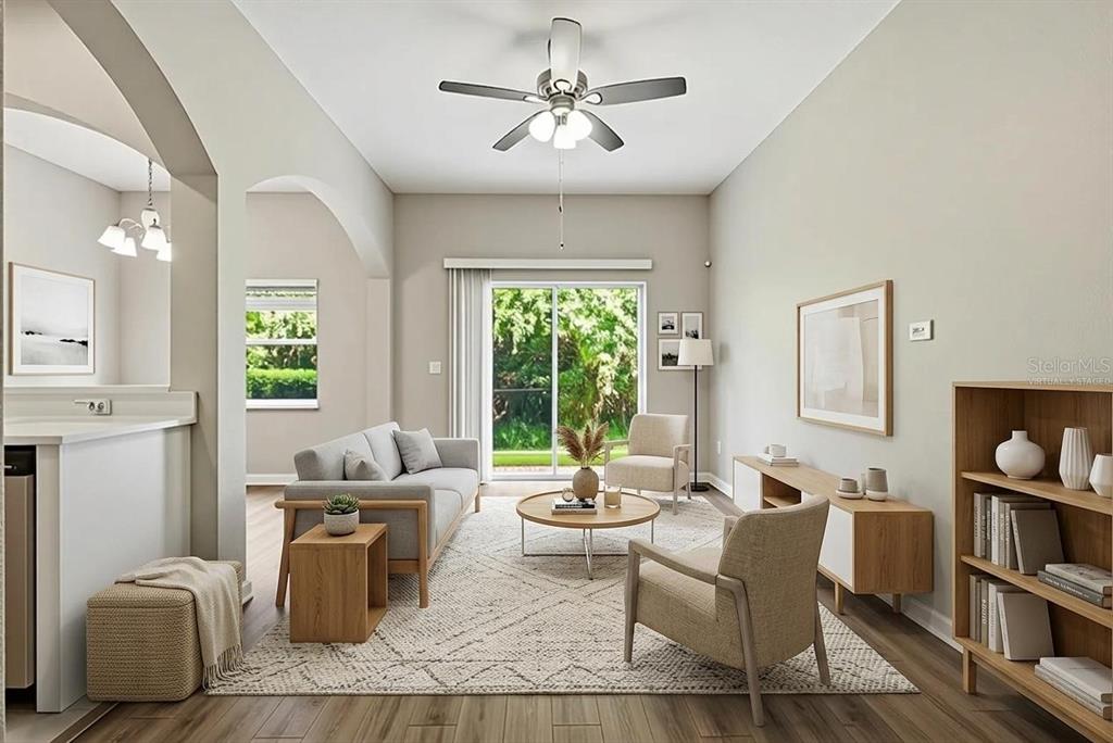 A living room with a sofa, armchairs, coffee table, and sliding glass doors to outdoors — 901 PINE POINTE LANE, ORLANDO, FL