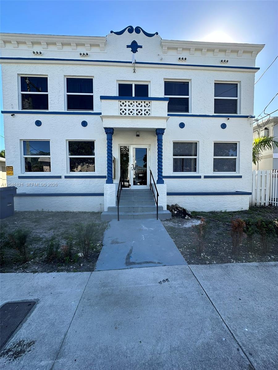 A two-story white building with blue trim features a central entrance with a small balcony — 1450 SW 4th St # 2, Miami FL 33135, MIAMI, FL