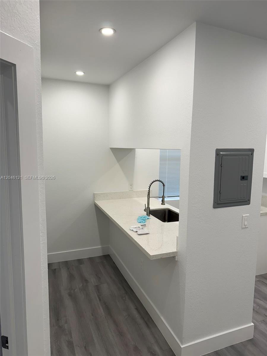 A kitchen area features a white quartz countertop, a sink, and gray wood-look flooring — 1450 SW 4th St # 2, Miami FL 33135, MIAMI, FL