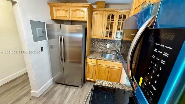 A kitchen features light wood cabinets, stainless steel appliances, and granite countertops — 1945 NW 29th St # A8, Miami FL 33142, MIAMI, FL