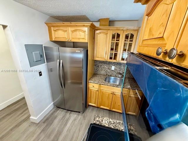 A kitchen features light wood cabinets, stainless steel appliances, and granite countertops — 1945 NW 29th St # A8, Miami FL 33142, MIAMI, FL
