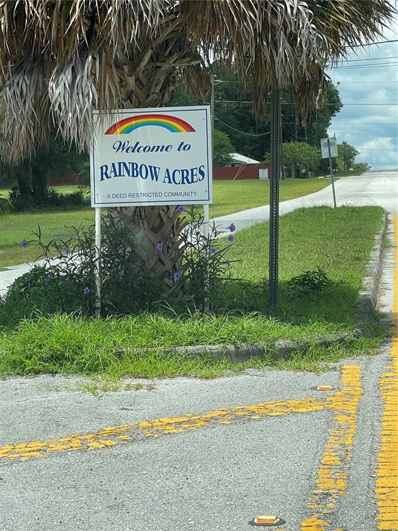 A sign for Rainbow Acres, a deed restricted community, stands in front of a palm tree — TBD SW 59TH LANE, DUNNELLON, FL