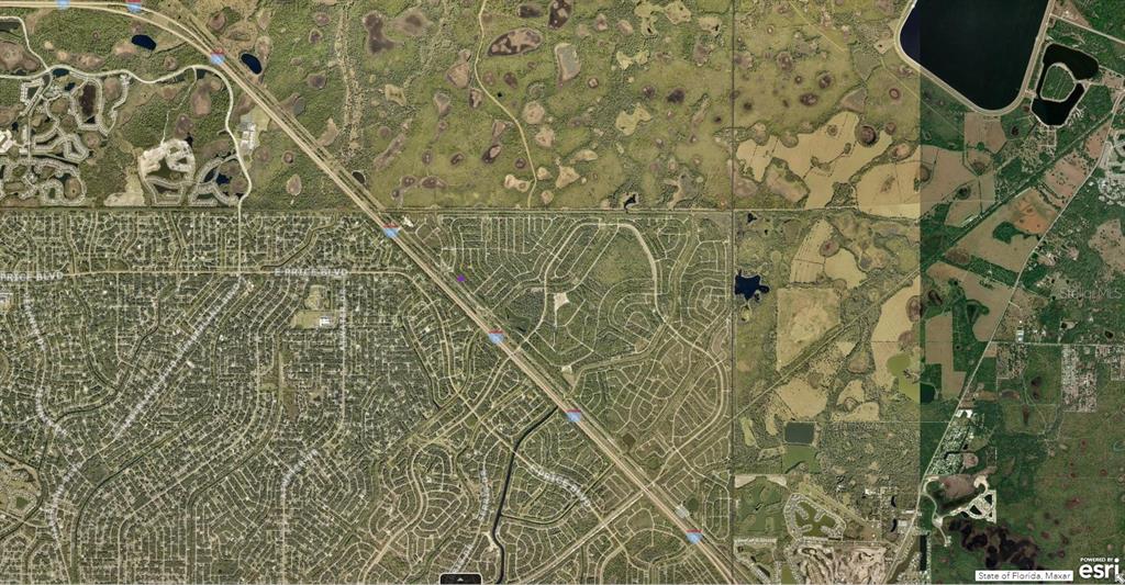 This is an aerial map view of a residential area with surrounding undeveloped land — 1124232509 LANGLAIS DRIVE, NORTH PORT, FL
