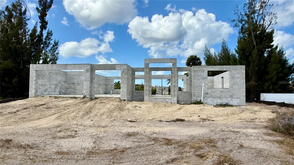 The exterior of a concrete block house under construction sits on a dirt lot — 2310 NW 35TH PLACE, CAPE CORAL, FL