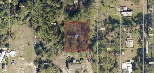 This aerial map shows a rectangular plot of land highlighted in red among surrounding properties — MARYLAND STREET, PAISLEY, FL