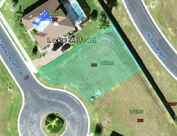 This is an aerial map showing a vacant residential lot highlighted in green — 210 SPRING AZURE DRIVE, LAKE ALFRED, FL