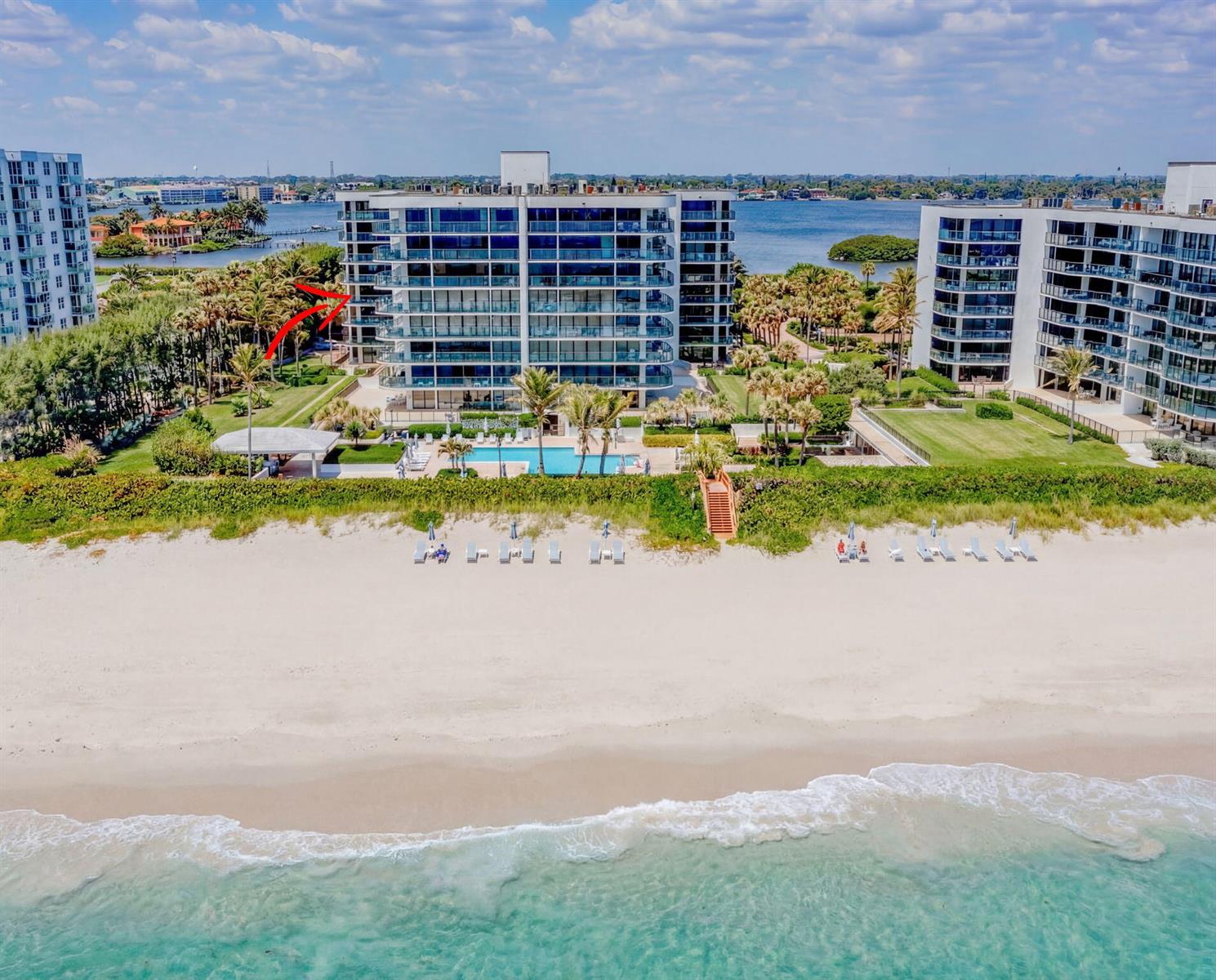 An aerial view of a beachfront condominium building with a pool and palm trees — 3440 S Ocean Boulevard # 204s, Palm Beach FL 33480, PALM BEACH, FL
