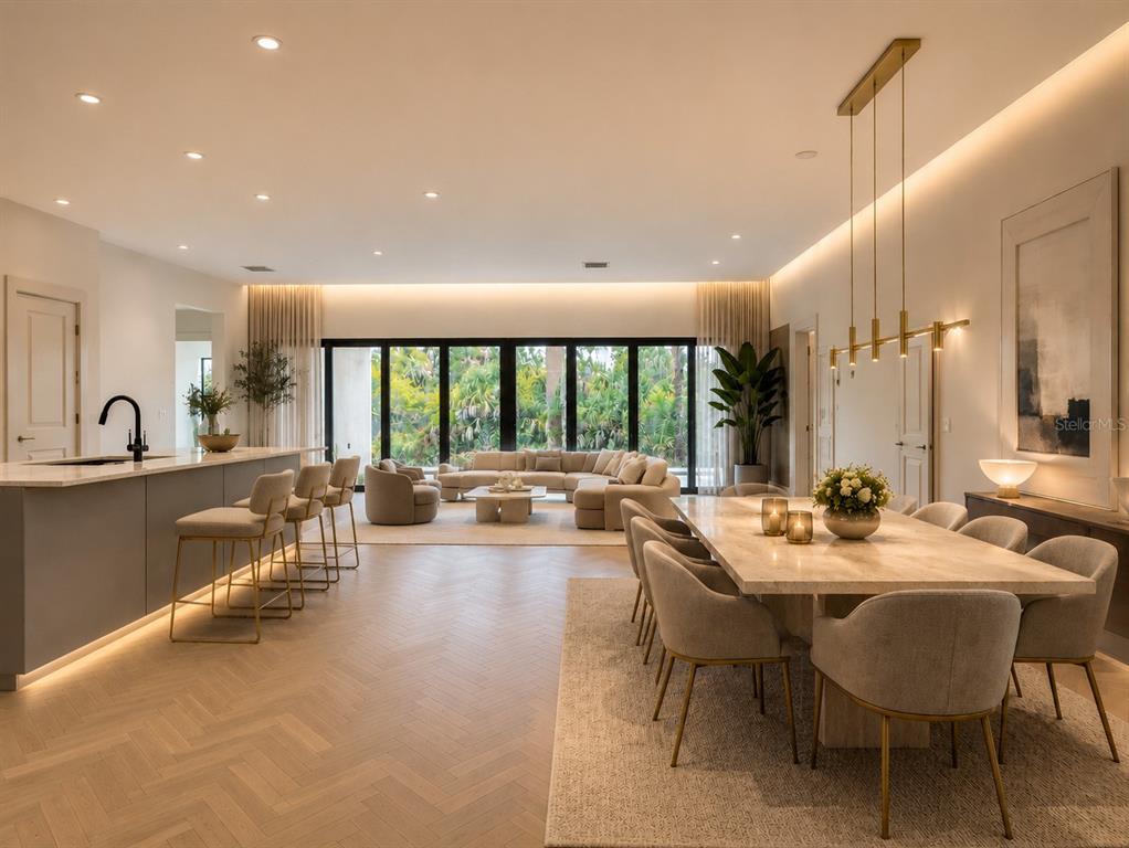 A modern open-concept living and dining area features herringbone wood floors and floor-to-ceiling windows — 7731 PINEDALE DRIVE, PORT CHARLOTTE, FL