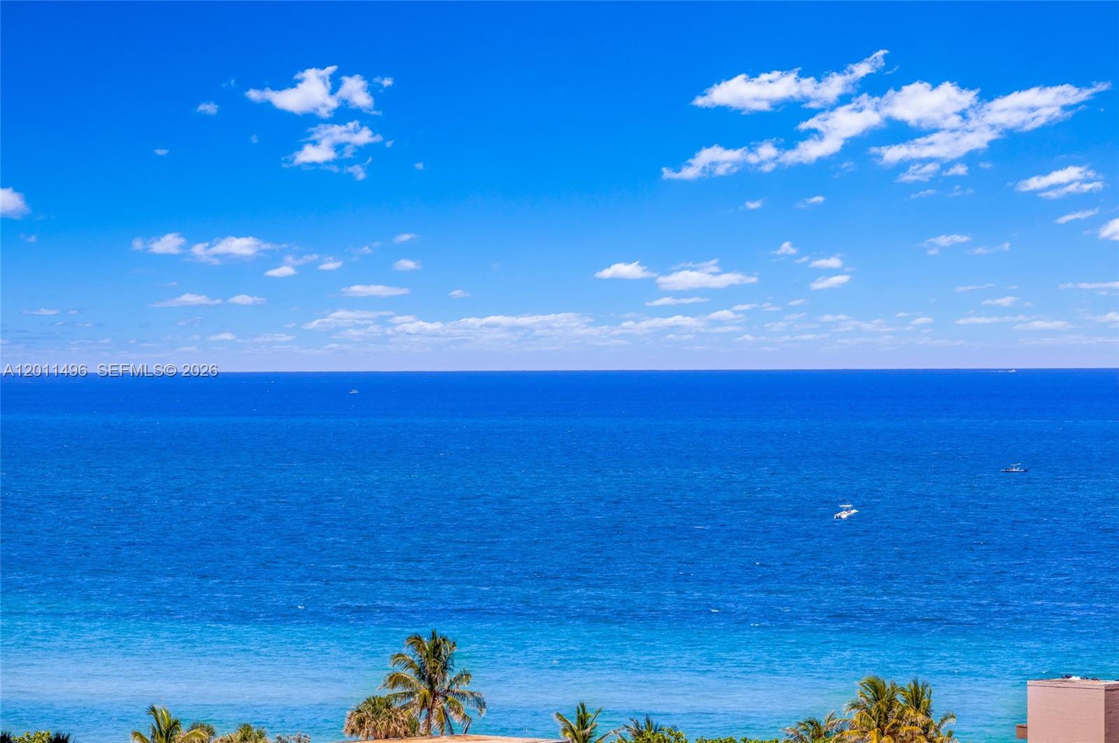 An elevated view of the ocean under a bright blue sky with scattered clouds — 1985 S Ocean Dr # 10B, Hallandale Beach FL 33009, HALLANDALE BEACH, FL